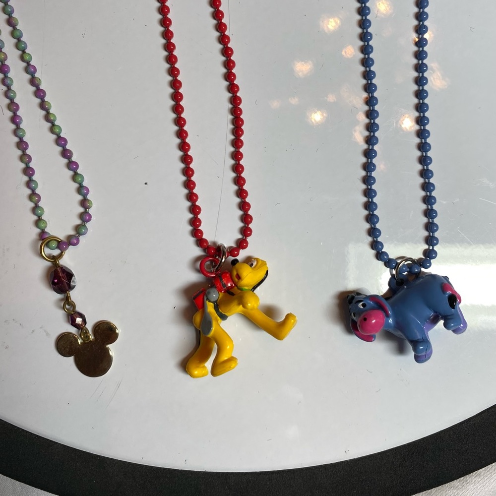 Disney Mickey, Pluto and Eeyore necklaces.